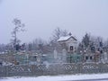 Cemetery. Old catholic church or Orthodox church. Rural landscape in snowy winter scene Royalty Free Stock Photo