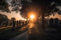 cemetery at sunset, with the sun setting behind a row of headstones