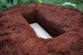 Cemetery, White coffin in grave hole before burried Royalty Free Stock Photo