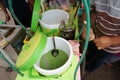 Hand are mixing Cendol with coconut milk , Indonesia desserts called Cendol