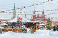 Cenery of the festive Red Square in winter Moscow. Christmas decorations near the Moscow Kremlin during snowfall Royalty Free Stock Photo