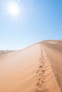 Cenic ridges of sand dunes with footprints in Sossusvlei, Namib Naukluft National Park, best tourist and travel attraction in Royalty Free Stock Photo