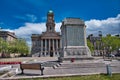 The Cenotaph and Town Hall in Hamilton Square in Birkenhead, Wirral Merseyside, taken on a sunny day with white clouds