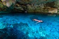 Cenote Dos Ojos in Quintana Roo, Mexico. People swimming and snorkeling in clear blue water. This cenote is located close to Tulum Royalty Free Stock Photo