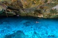 Cenote Dos Ojos in Quintana Roo, Mexico. People swimming and snorkeling in clear blue water. This cenote is located close to Tulum Royalty Free Stock Photo