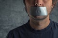 Censorship concept, man with duct tape on mouth