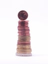 1 cent coin standing on top of stack of euro coins. Royalty Free Stock Photo