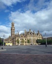 centenary square in bradford west yorkshire with people sitting and walking past the city hall and magistrates court buildings