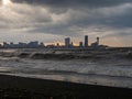 center of Batumi against the backdrop of big waves. The city against the backdrop of the rough sea. Houses in the distance. Bad