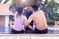 Center of love concept.Happy family father mother and daughter Hugging at swimming pool with happiness