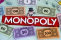 Center of Monopoly gameboard with money packs tokens and dice. Royalty Free Stock Photo