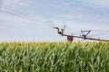 Center pivot irrigation system watering corn crop during summer Royalty Free Stock Photo