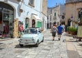 Center of Polignano a Mare, with tourists and Fiat 500 from the 50s