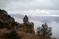 The rock formation in the Grand Canyon looks like a person in heavy clothes sitting on a stone chair holding a potted plant, cont