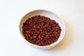 Centered view of white bowl of Capsicum annuum Pequin pepper dried red piquin bird peppers