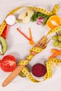 Tape measue with fruits and vegetables in shape of clock showing time to healthy eating and slimming