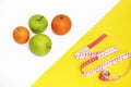 Centimeter tape and fresh fruit, apples, oranges Royalty Free Stock Photo