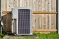 Central air conditioning unit in a residential backyard. Royalty Free Stock Photo