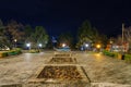 Central alleys of the city park in the dark of the night. Background with copy space Royalty Free Stock Photo