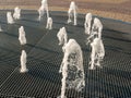 Central fountain. Jets of water rise up and scatter into small drops. Close-up. Noyabrsk, Russia Royalty Free Stock Photo