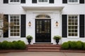 central front door of a colonial house with symmetrical windows