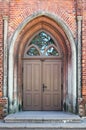 The central front door to the old public medieval brick church Royalty Free Stock Photo