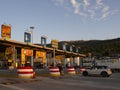 Central Greece. December 2019: Trip on the toll highway Athens-Thessaloniki, past cars, gas stations, toll checkpoints at sunset i