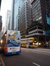 A photo of one of the many doubledeck buses driving around on Des Voeux Road Central in