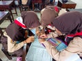 A group of students are learning to recognize and translate the Javanese script in class. Royalty Free Stock Photo