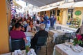 Central Kapodistriou street in Corfu, full of tourists eating in various restaurants