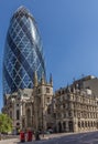 CENTRAL LONDON / ENGLAND - 18.05.2014 - The Gherkin sky-scraper is seen behind the St. Andrew Undercroft medieval church in London