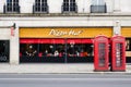 Central London Pizza Hut restaurant with two red classic telephone call boxes Royalty Free Stock Photo