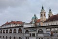 Central Market of Ljubljana, with the Ljubljanica river on foreground and the Ljubljana Cathedral in the background Royalty Free Stock Photo