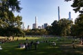 Central Park Sheep Meadow with Many People during Summer and the Midtown Manhattan Skyline Royalty Free Stock Photo