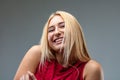 Blond woman smiling, playful, perhaps mischievous or shy Royalty Free Stock Photo