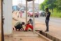 Unidentified Ghanaian man treats his friend's wound in local vi