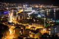 Central road is along the coast, through the modern part of the city of Budva. Aerial view at night time. Montenegro, Europe