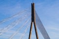 Central support of cable-stayed bridge with anchoring cables on blue sky background Royalty Free Stock Photo