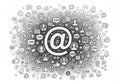 Central @ symbol surrounded by a dense array of social media and communicat Royalty Free Stock Photo