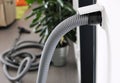 Central vacuum cleaner hose plugged in to wall inlet Royalty Free Stock Photo