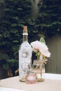 A Centre piece wine bottle on a vintage look wedding table