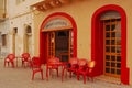 Centru Laburista, a colourful restaurant entrance with table chair at seaside waterfront fishing village of Marsaxlokk, Malta