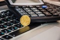 20 cents on a laptop keyboard. Coin and calculator on the keyboard, close-up. Royalty Free Stock Photo