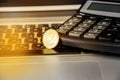 20 cents on a laptop keyboard. Coin and calculator on the keyboard, close-up. Royalty Free Stock Photo