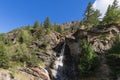 Centuries-old granite karst rocks have formed crevice in rock along which silvery streams of Lillaz waterfall Cascate di Lillaz