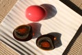 Century egg, traditional chineese and thai food. Whole egg with pink eggshell and black peeled egg sliced into halves