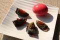 Century egg, traditional chineese and thai food. Whole egg with pink eggshell and black peeled egg sliced into quarters