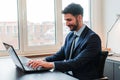 Ceo business man working with laptop sitting at office desk. Successful executive businessman wearing suit using a Royalty Free Stock Photo