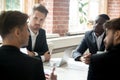 CEO discussing corporate matters with employees in office. Royalty Free Stock Photo