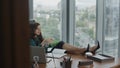 Ceo woman sitting office desk thinking about career. Girl putting legs on table. Royalty Free Stock Photo